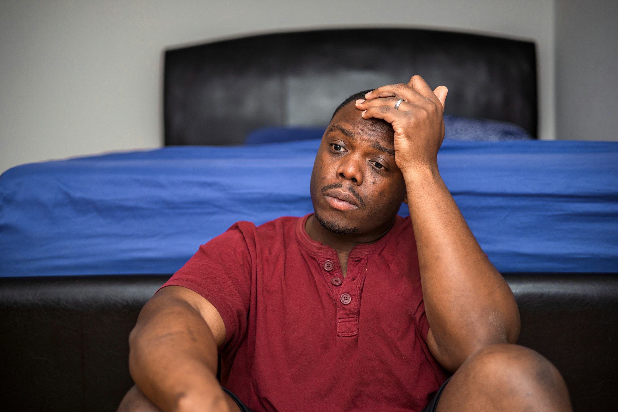 Mental health concept an African American or black man at home looking sad depressed with anxiety